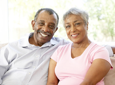 African couple Smiling and posing to camera in living room