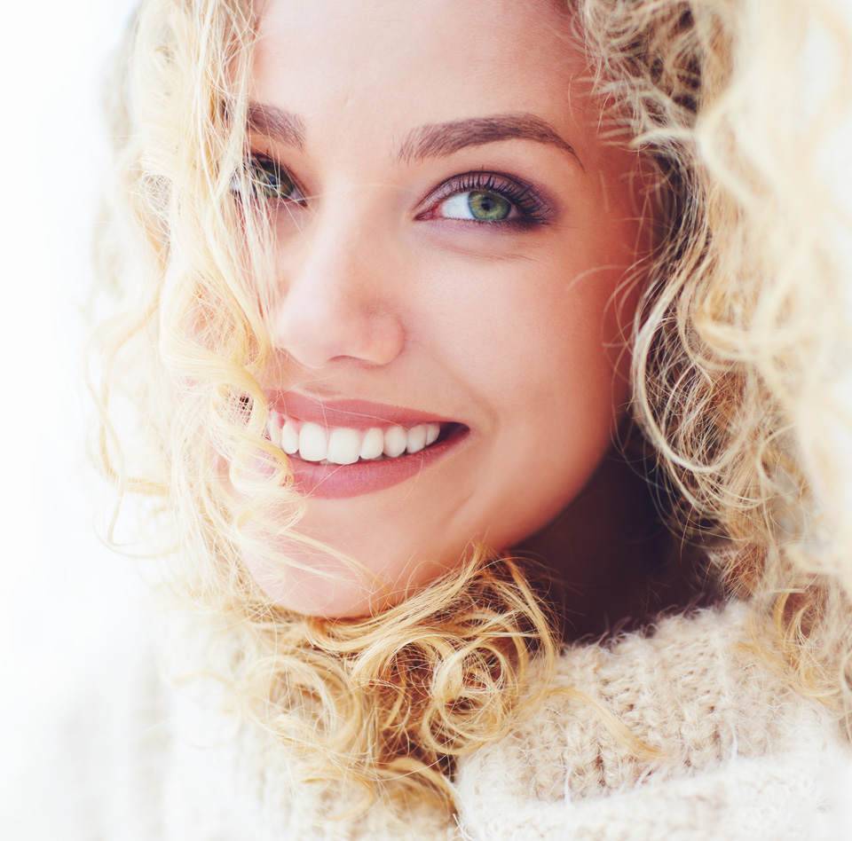 Portrait of beautiful woman with curly hair and adorable smile