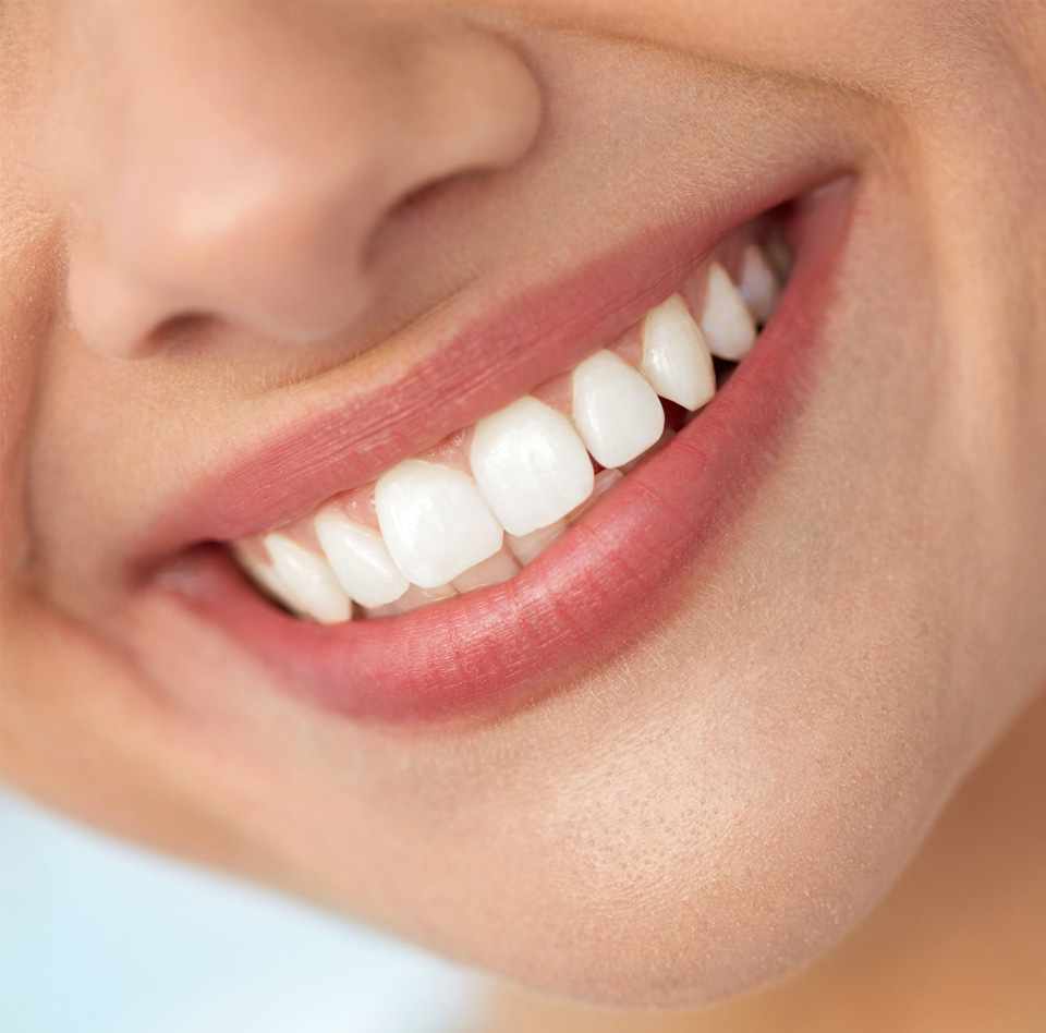 Closeup Of Smiling Woman Mouth With Natural Plump