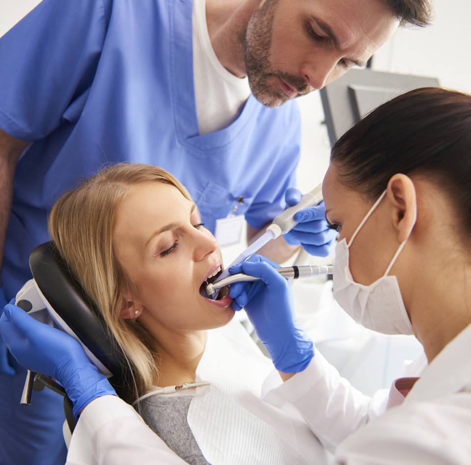 Young woman is getting treatment in dentist's office