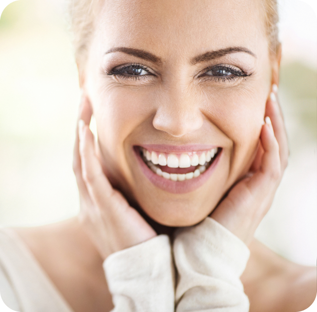 Closeup portrait of an attractive mid 30's woman gently touching her neck and smiling