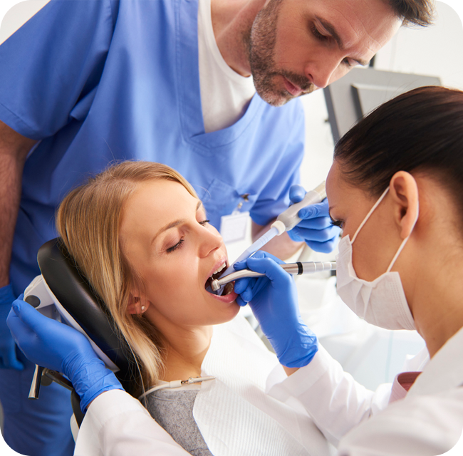 Young woman is getting treatment in dentist's office
