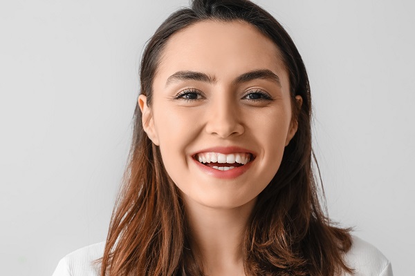 Young,Woman,With,Beautiful,Smile,On,Grey,Background,,Closeup